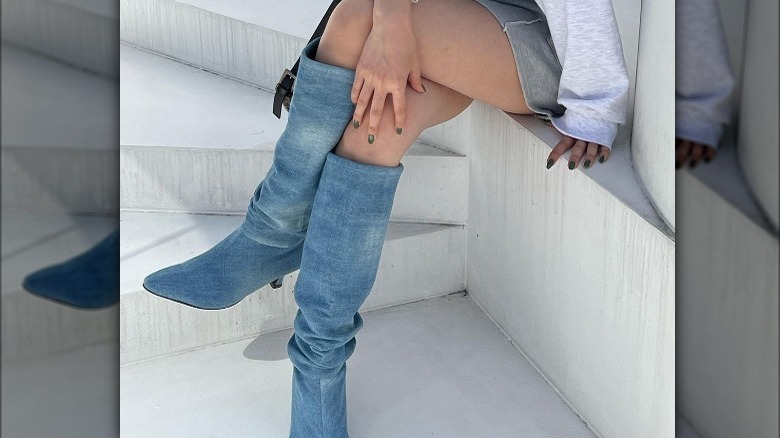 woman wearing tall denim boots