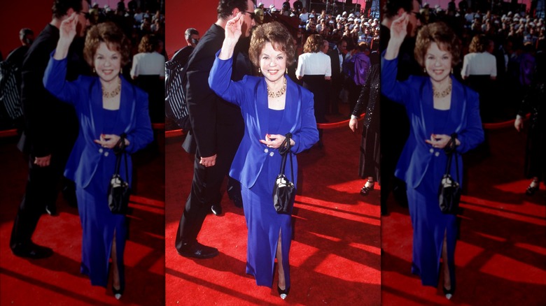 Shirley Temple wearing a cobalt suit and blazer in 1998