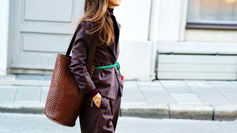 Woman carrying brown bucket bag
