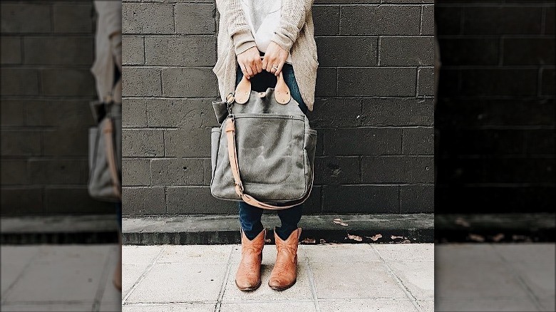 Hands holding canvas bag
