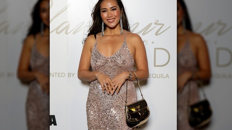 Diana Chan wearing shiny outfit, handbag