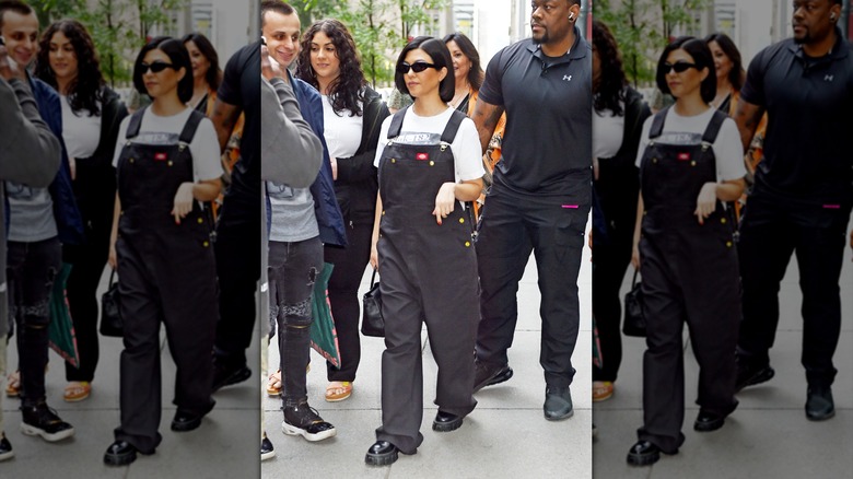 Kourtney Kardashian wearing overalls while pregnant