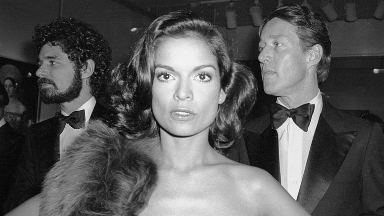 Black and white photo of Bianca Jagger with a fur stole.