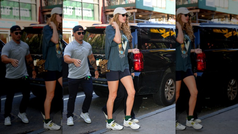 Taylor Swift on the street in a baseball cap, oversized tee and bike shorts