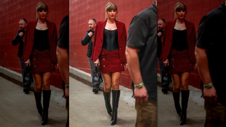 taylor Swift wearing a plaid set with boots