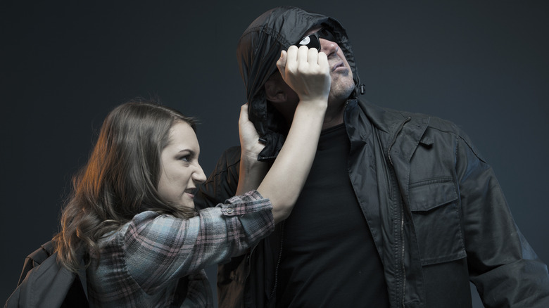 Woman hitting man in the eye