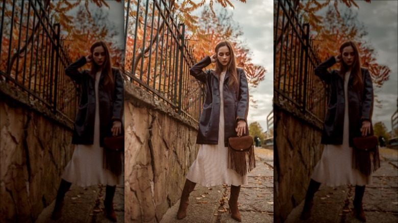 woman wearing brown jacket over white dress on sidewalk