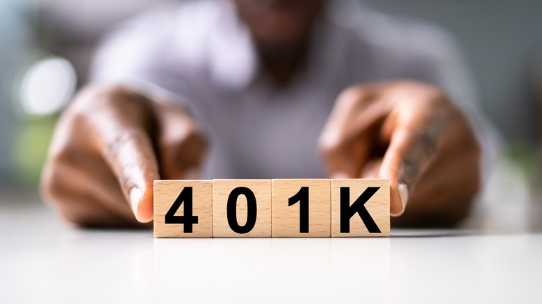 man holding 401K tiles