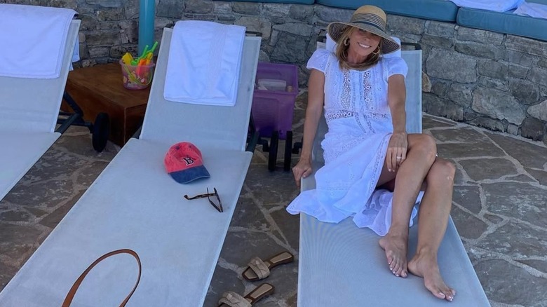 Cheryl Hines posing in Greece in a white lace dress