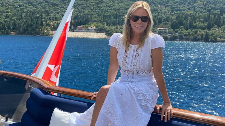 Cheryl Hines posing in Greece in a white lace dress