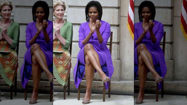 Michelle Obama in 2009 clapping in a purple dress