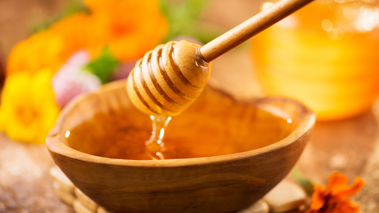 honey wand carrying honey out of a bowl