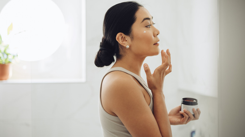woman applying face cream