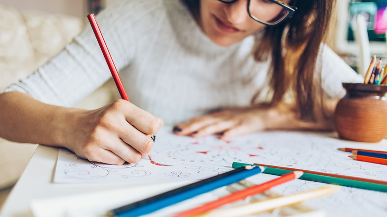 woman doodling using colored pencil