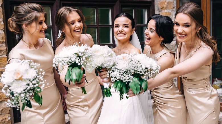 Bride smiling with bridesmaids