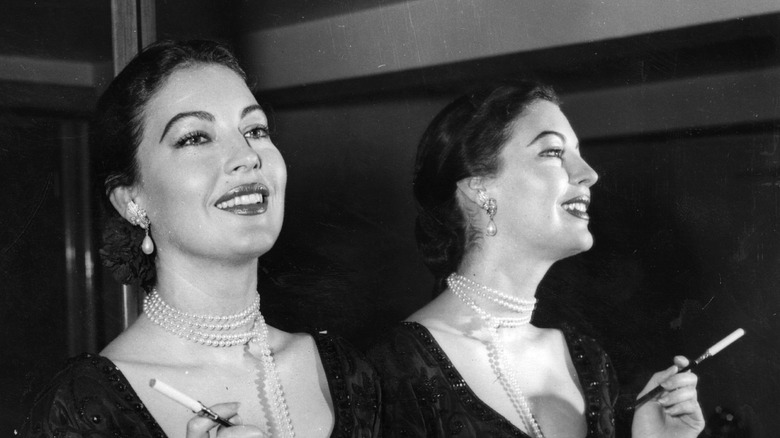 Ava Gardener holding a long cigarette holder