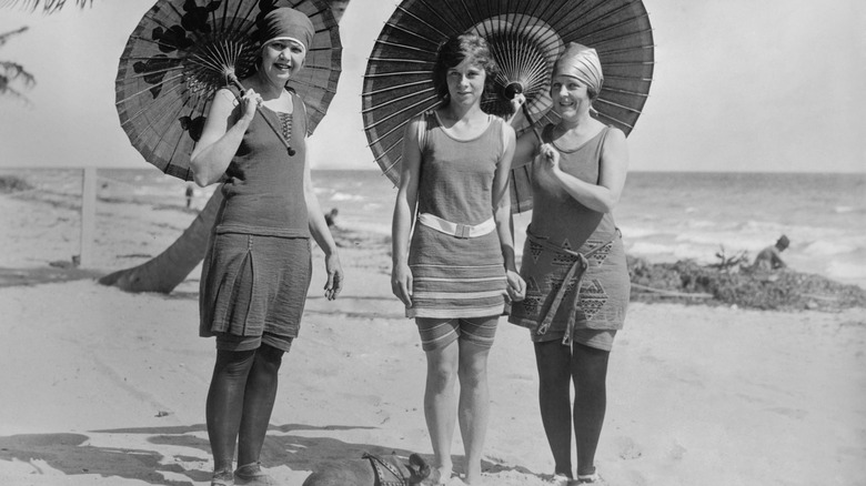 Women in the 20s wearing modest bathing suits at the beach