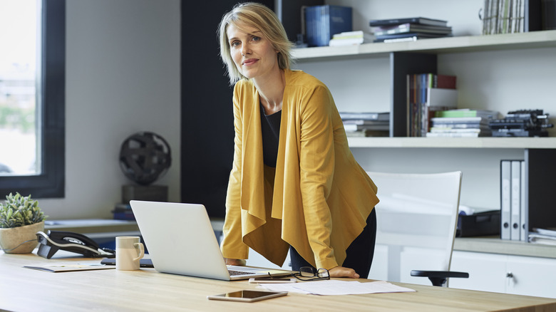 Woman yellow jacket work desk