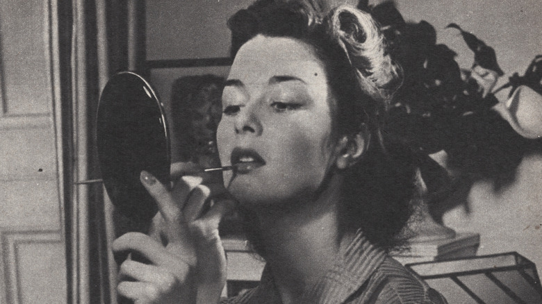 Woman applying makeup