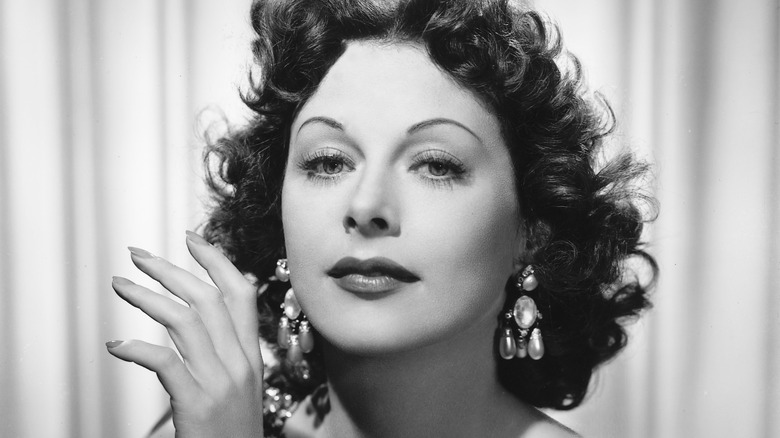 A black and white image of a woman with earrings