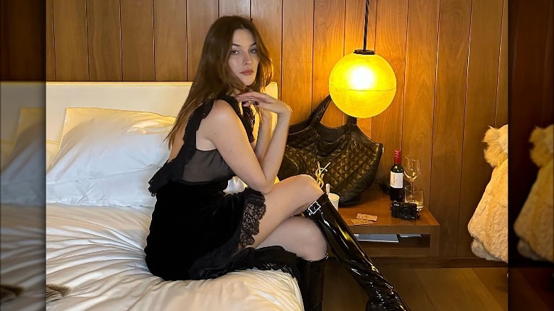 Camille Charriere sitting on bed