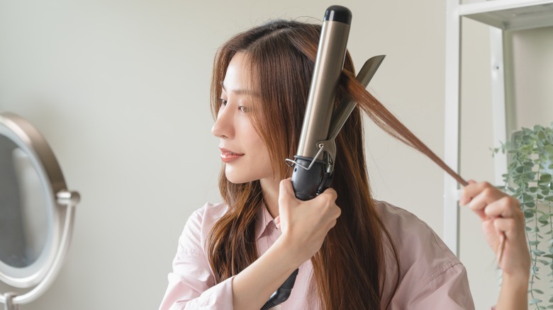 Woman using a curling iron
