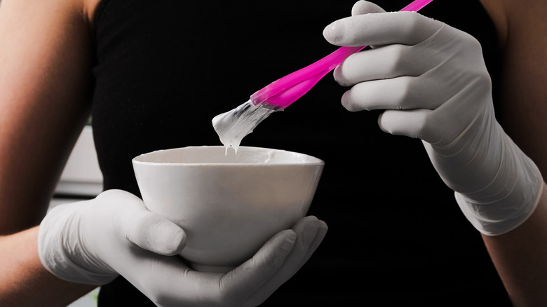 Woman holding bowl of hair dye