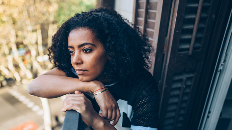Sad, wistful woman on balcony