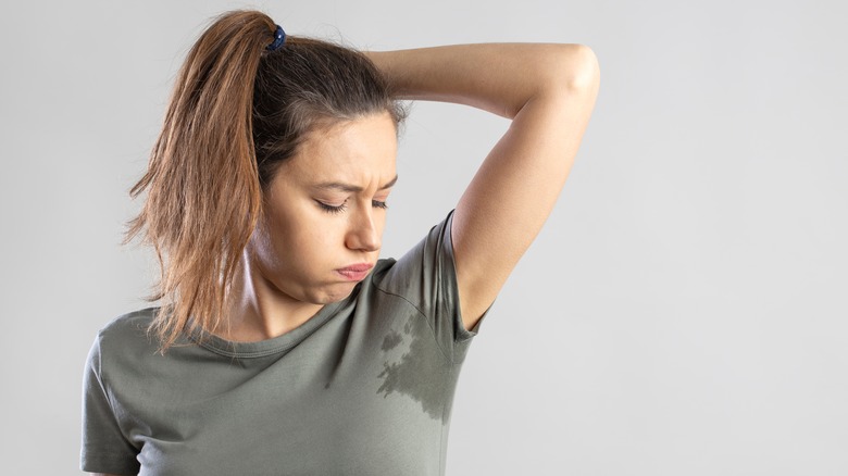 woman smelling her armpit