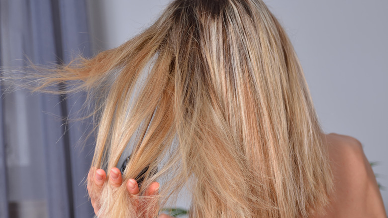 Blond styling her hair