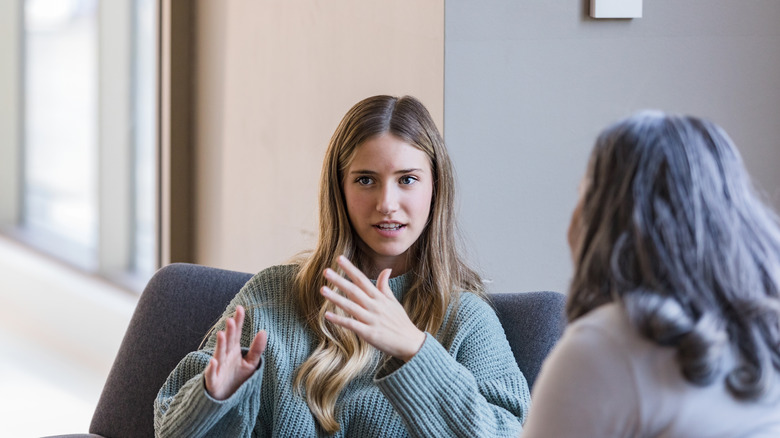 women talking on couch