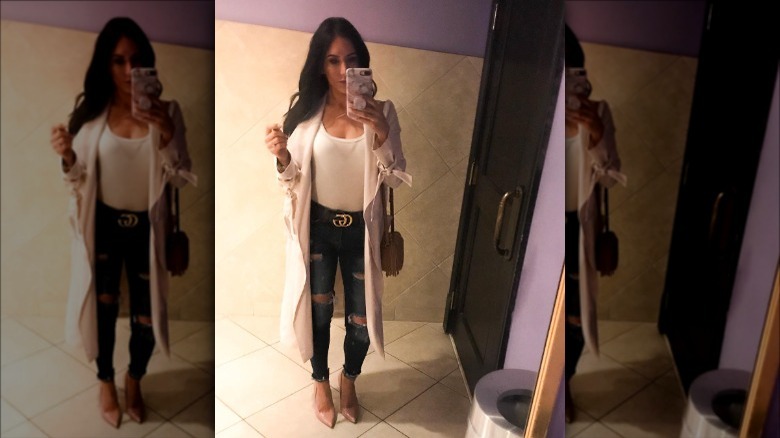 woman in bathroom wearing pink duster