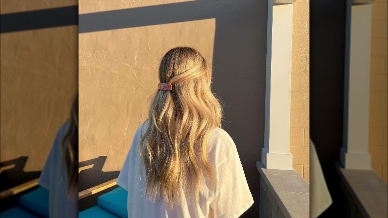 Person with a ponytail and Prada clip