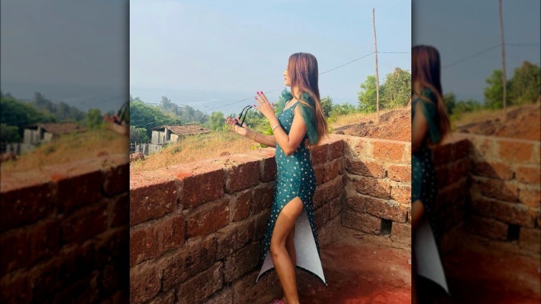 A woman in a leg slit dress