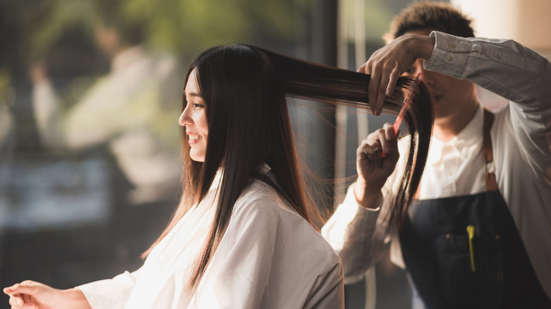 A woman getting her hair cut