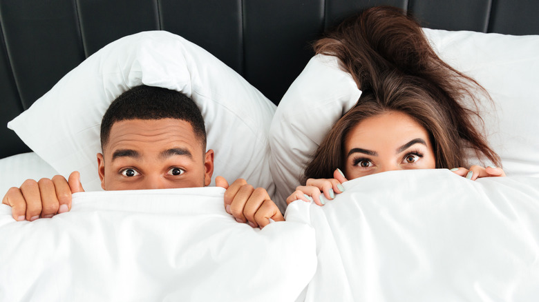 shy couple in bed