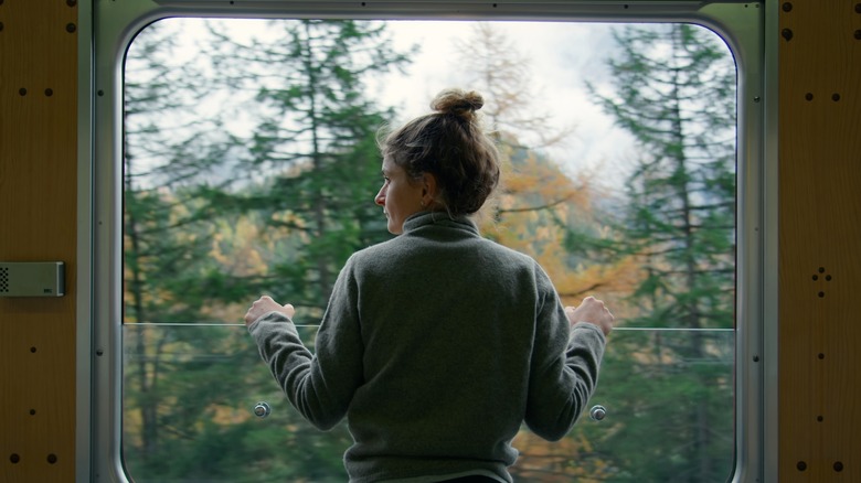 person looking out of window 