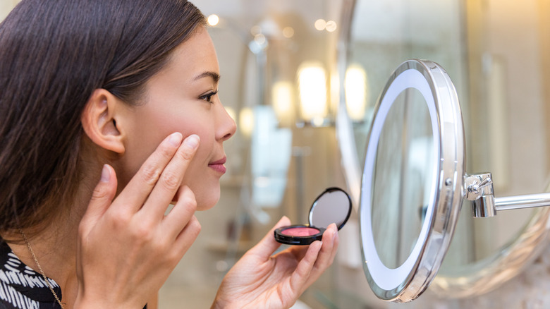 Woman applying blush