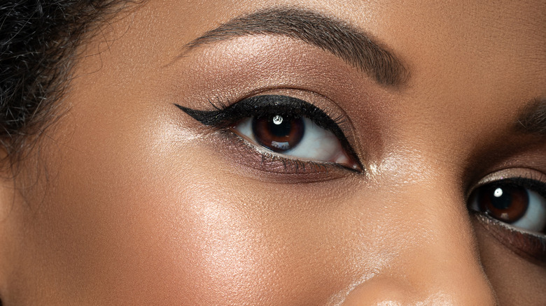 Woman applying eyeliner