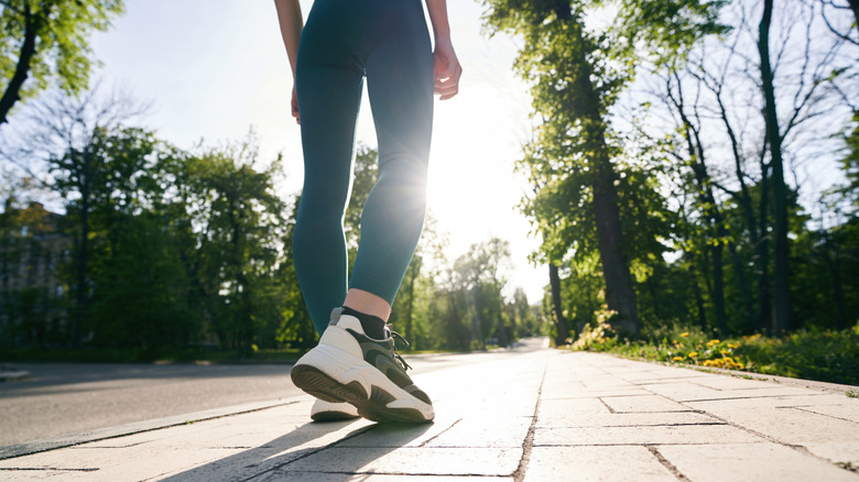 Person in teal leggings and sneakers