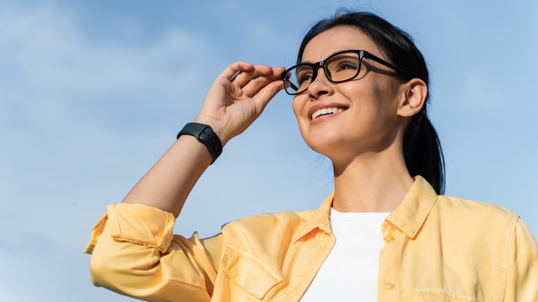 woman against sky background with glasses