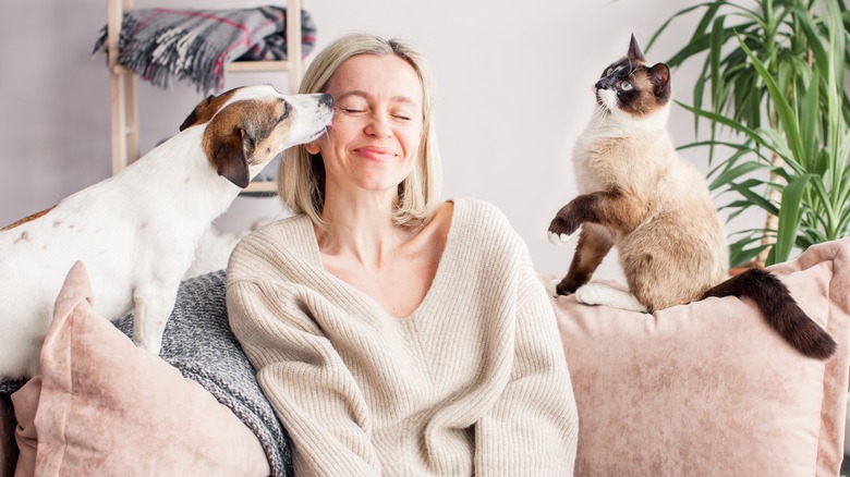 Woman with cat and dog 