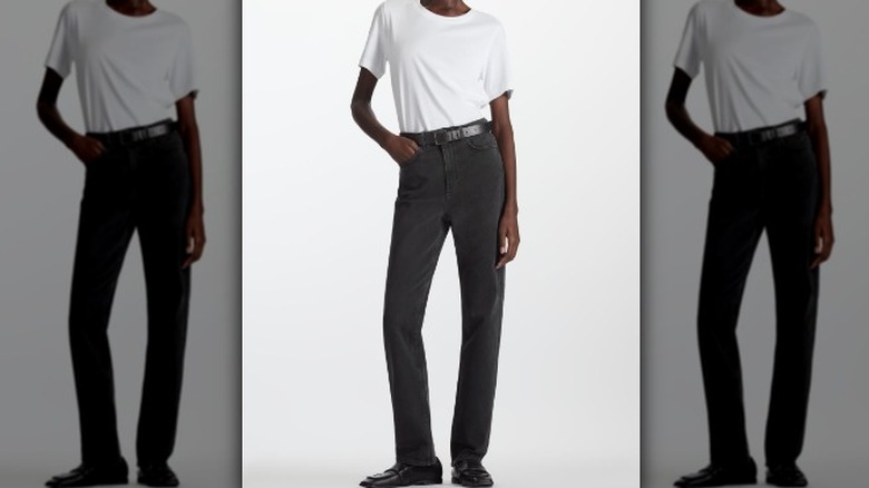 Person in black jeans with white tank top