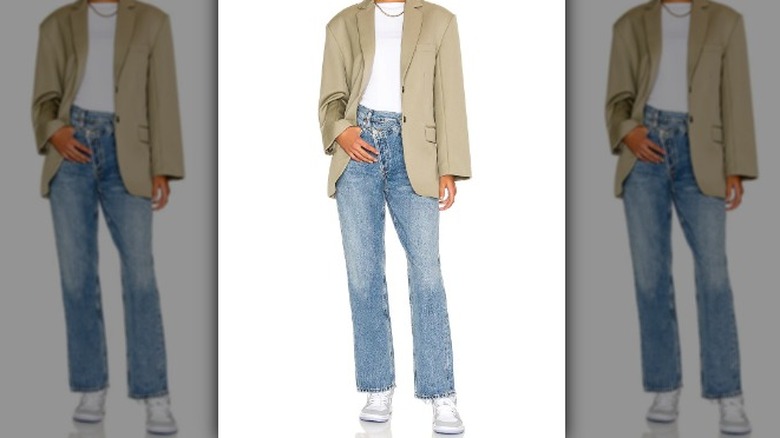 Person in criss-cross denim and green blazer