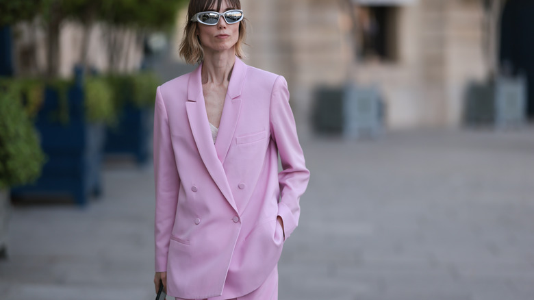 woman wearing oversized pink pantsuit