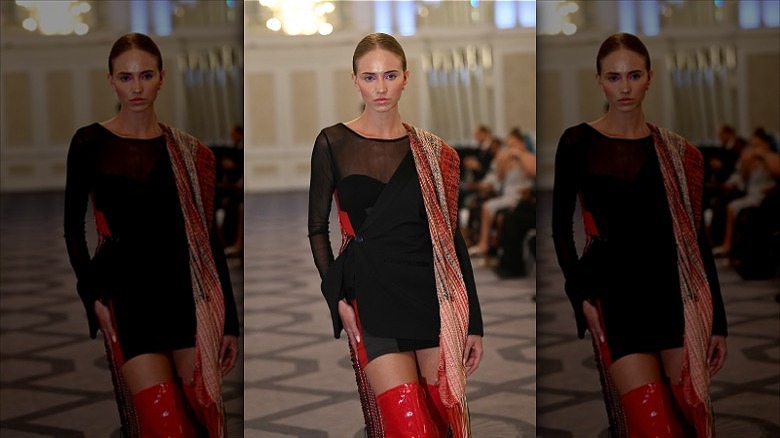 runway model wearing sheer black dress