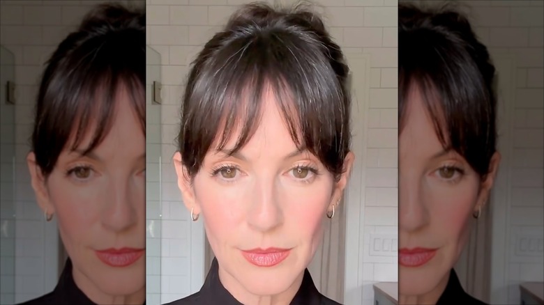 A woman with curtain bangs.