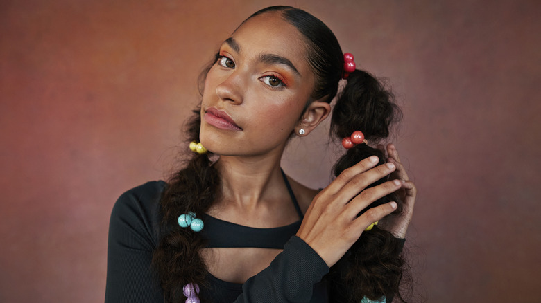 A woman wearing colorful hairties.
