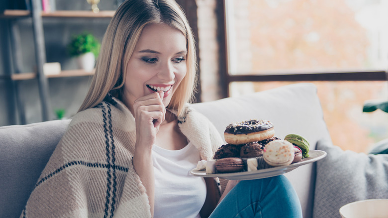 woman with plate of baked goods