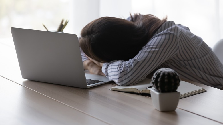 woman sleeping on desk
